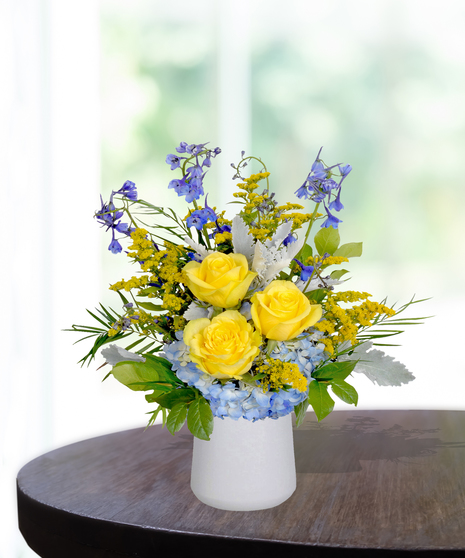 Sassy Sapphire flower arrangement with blue delphiniums, white lilies, and seasonal blooms