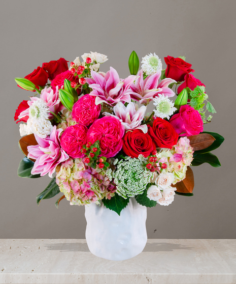 Chanel Signature Collection flower arrangement with hot pink roses, garden roses, white spray roses, Queen Anne’s lace, and more from Billy Heroman’s florist in Baton Rouge.