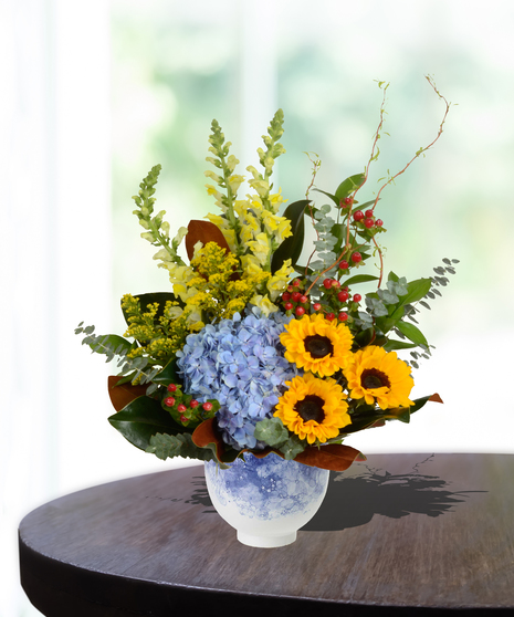 Mother's Garden Flower Arrangement: A vibrant mix of roses, lilies, and daisies in a charming basket