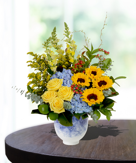 Mother's Garden Flower Arrangement: A vibrant mix of roses, lilies, and daisies in a charming basket