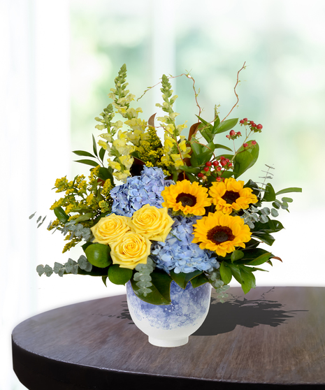 Mother's Garden Flower Arrangement: A vibrant mix of roses, lilies, and daisies in a charming basket