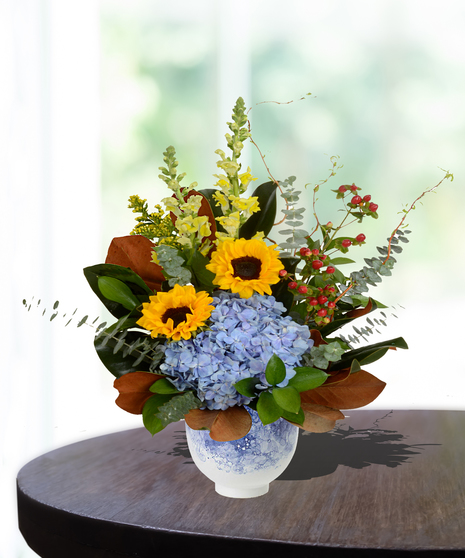 Mother's Garden Flower Arrangement: A vibrant mix of roses, lilies, and daisies in a charming basket