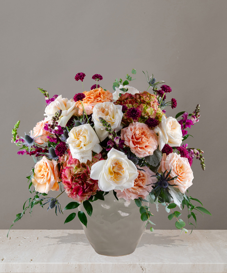 Amber signature flower arrangement by Billy Heroman’s, featuring white garden roses, shimmer roses, and hydrangeas.