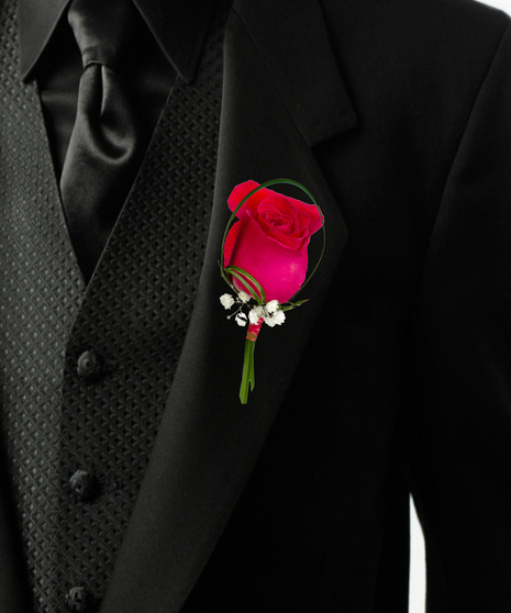 a single rose bouttonière with baby breath and lily grass