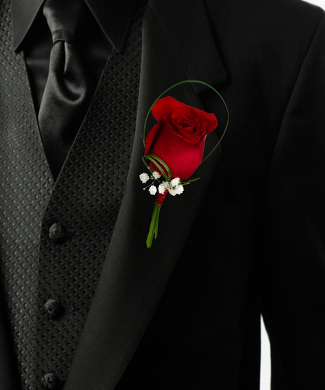 a single rose bouttonière with baby breath and lily grass