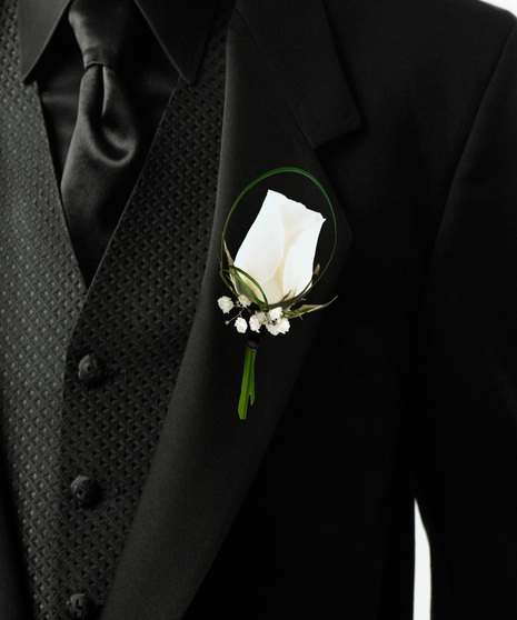 a single rose bouttonière with baby breath and lily grass