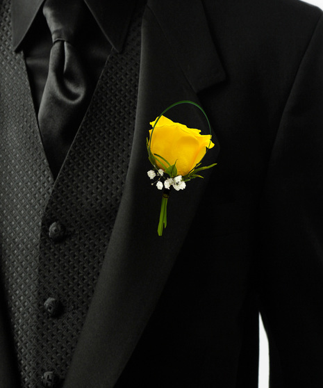 a single rose bouttonière with baby breath and lily grass